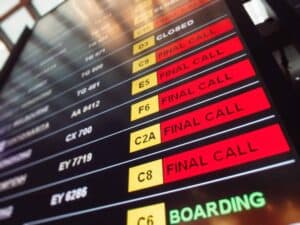Many red sign final call flights on the departure table of an airport