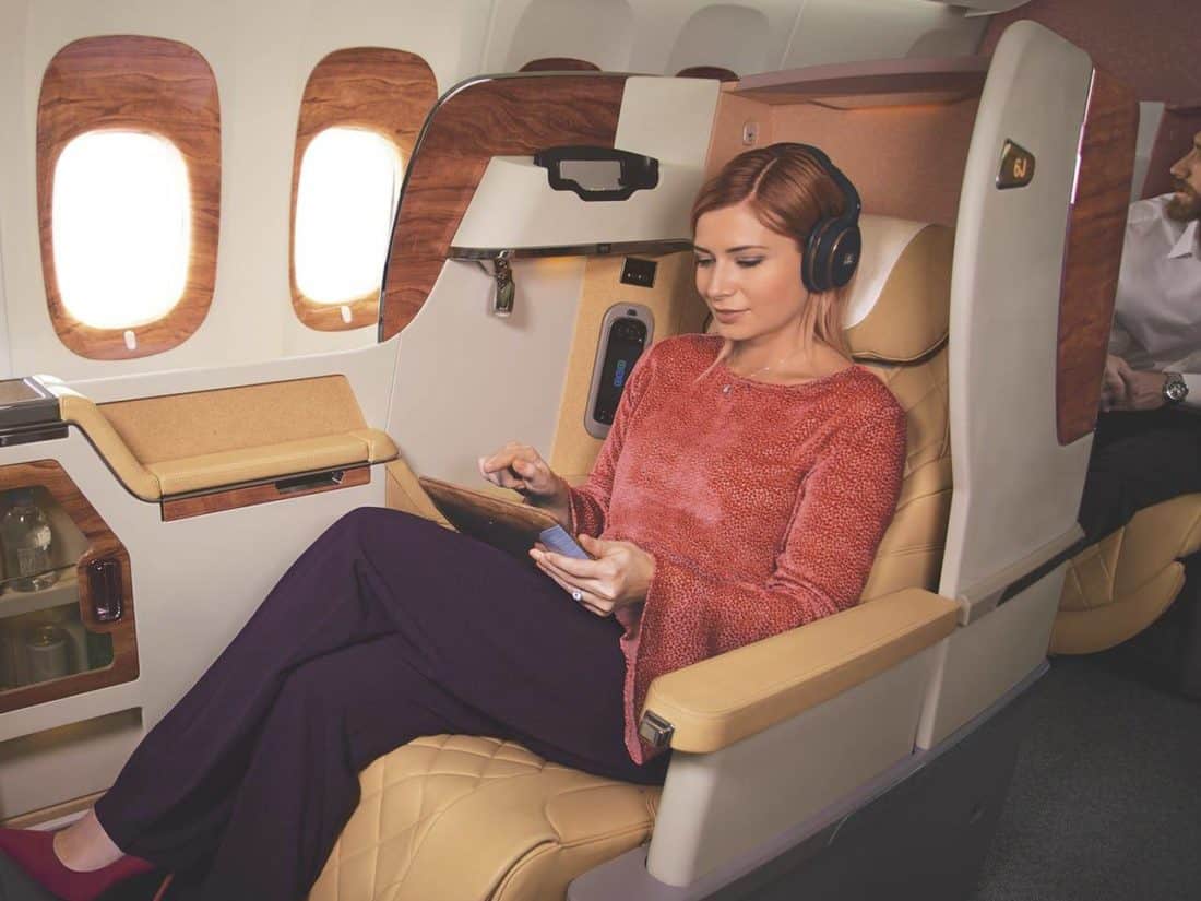emirates woman on business class listening to music w1280x960